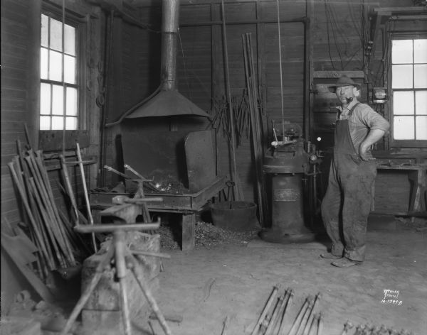 View of the Linden blacksmith shop, showing forge and equipment. The introduction of motorized farm equipment and automobiles led to the virtual disappearance of some breeds of draft horses and the need for blacksmiths. In 1931 this Iowa County smith was one of a rapidly declining population.