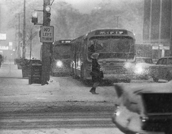 Winter scene of a snowstorm that hit Milwaukee just at rush hour creating a traffic headache for homebound commuters (seen here at Wisconsin and Milwaukee streets), although only four inches of snow fell.