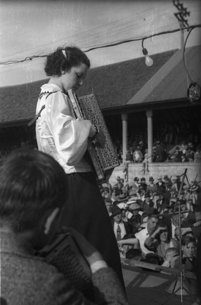 A young accordionist plays a solo for the crowd at the Wisconsin State Fair, while another young player watches.