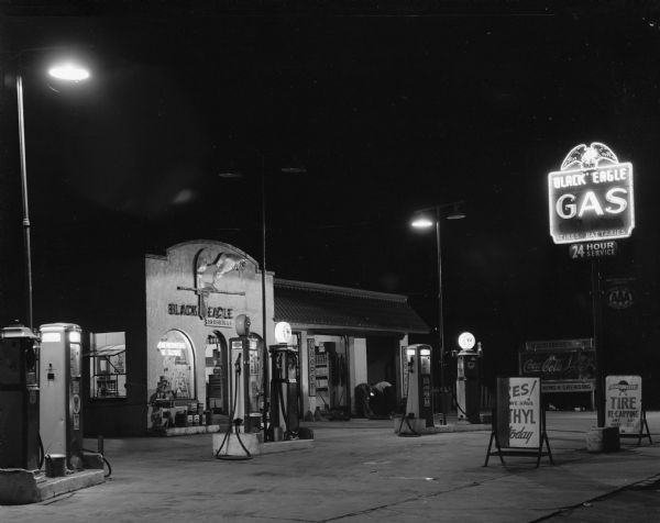 The H.W. Risberg & Sons Black Eagle Service Station, located at 1200 East Washington Avenue, at night.