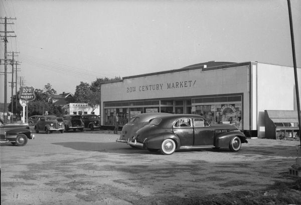 Exterior of the 20th Century Market, 2701 University Avenue, a new supermarket on Madison's growing western edge.  Several cars are parked in the parking lot.