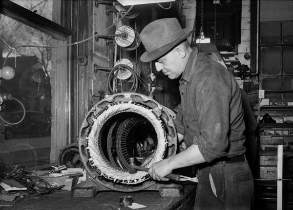 A man works on an armature at Fuller & Johnson, 52 North Dickinson Street. Fuller&Johnson produced war material during World War II.