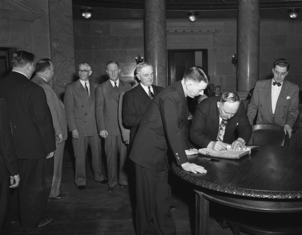 Wisconsin State Senators signing-in in the Senate Chambers of the  Wisconsin State Capitol.