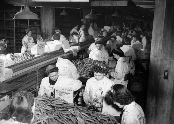 Female employees processing "Yellow Band" weiners at the Oscar Mayer Company during World War II.