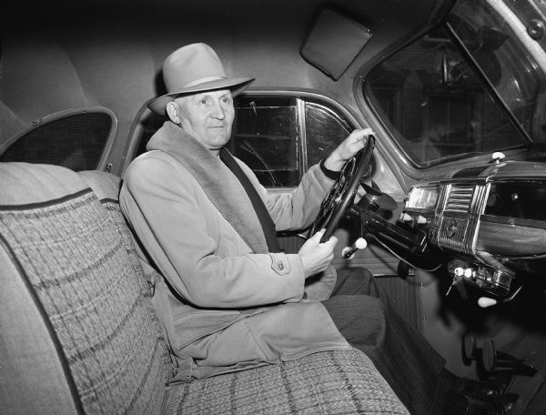 Driver of the week, Elmer L. Nordness of 2406 Gregory Street in his car.  Nordness was chosen as the <I>Wisconsin State Journal's</I> "Courteous Driver of the Week" by the American Automobile Association.