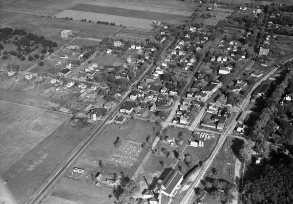 Aerial view of Middleton including businesses, residences, the railroad tracks, and the surrounding countryside.