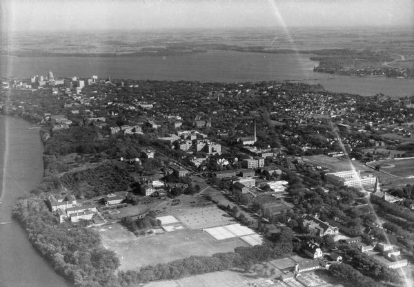 Aerial view looking southeast, towards the city, including the Wisconsin State Capitol, the central business district, the Capitol Square, both Lake Mendota and Lake Monona, and the University of Wisconsin-Madison campus.