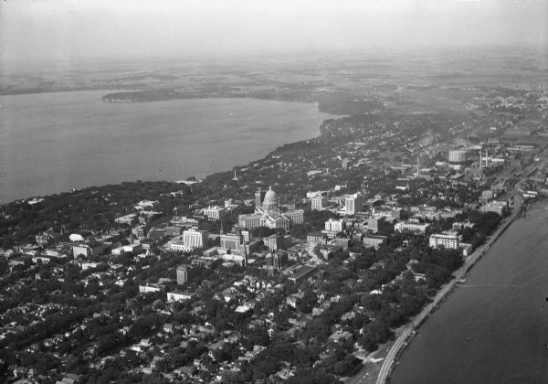 Aerial view of the city, including the Isthmus, the Wisconsin State Capitol, the downtown business district, Lake Mendota, and Lake Monona.