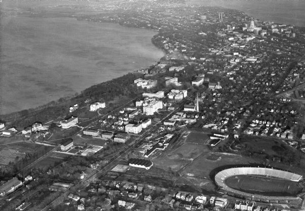 Aerial view of the University of Wisconsin-Madison campus including Camp Randall Stadium, the Wisconsin State Capitol, and both Lake Mendota and Lake Monona.
