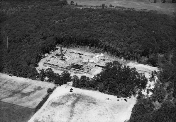 Aerial view of a construction site surrounded by woods. Lake View Tuberculosis Sanatorium(?).