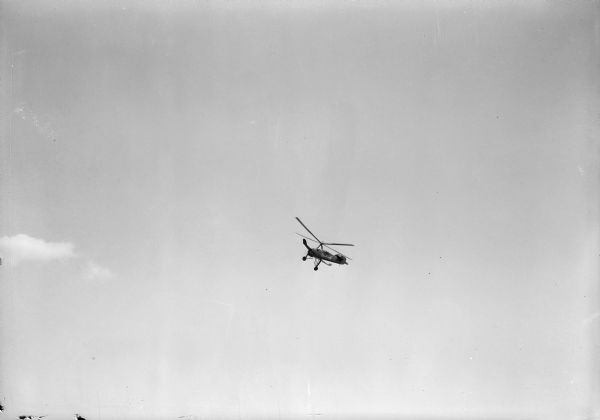 An Autogiro in flight over Madison.