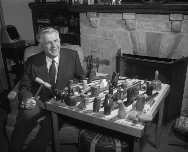 Methodist Bishop Northcott posing with his collection of gavels.