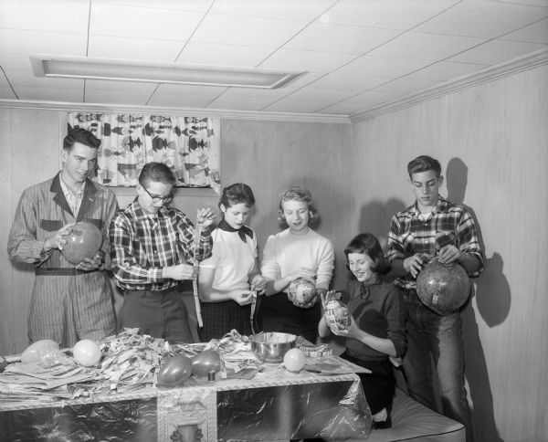 David Ahlgren, Fritz Hasler, Ellen Cline, Sally Wagner, Kathy Taylor and John Washa making decorations for the Young People's Assembly holiday party to be held at the University Club.