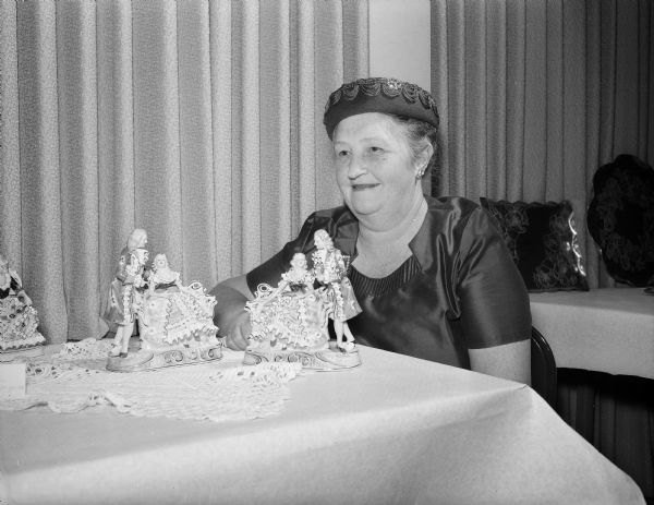 Frieda Luloff (Mrs. Harold L.) with her collection of Dresden and German bisque figurines at the East Side Women's Hobby Show.