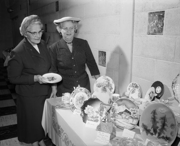 Helen Quale (Mrs. O.H.) and Leatha Premo (Mrs. Lewis W.) with their china collection at the East Side Women's Club Hobby Show.