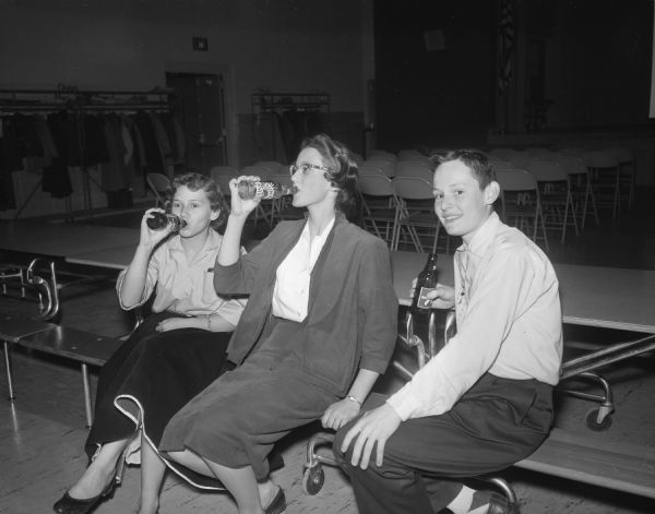 One chaperon and two students drinking sodas at a Cherokee Heights School Dance.