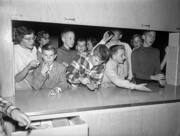 A group of students buying sodas at the refreshment counter at the Cherokee Heights School dance.