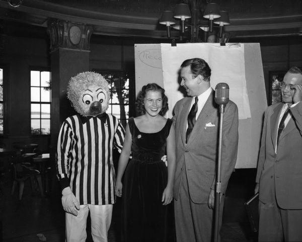 Walt Kelly posing with a Pogo impersonator (left), Jo Ingelfield (center), who was selected to be Pogo's first lady if he successfully won his campaign for presidency of the swamp, and Carl Reich (right).
