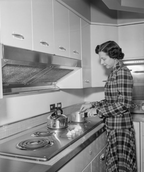 Pauline Rehder working in the Heart Kitchen at Madison Vocational and Adult School. The Heart Kitchen, for women with heart disease,  allows the cook to work with equipment at the proper height.