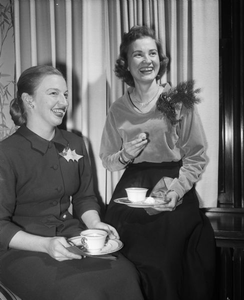 Mrs. Truman Graf and Mrs. John L. Adams, members of the School of Agriculture Daughters of Demeter, enjoying a Christmas tea and program in the University of Wisconsin Chancellor's Residence, 130 N. Prospect Avenue.