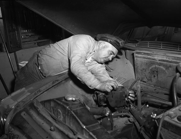 Franz Haas, sheriff elect, working under the hood of a car at his Standard Gas Station, 318 South Park Street.