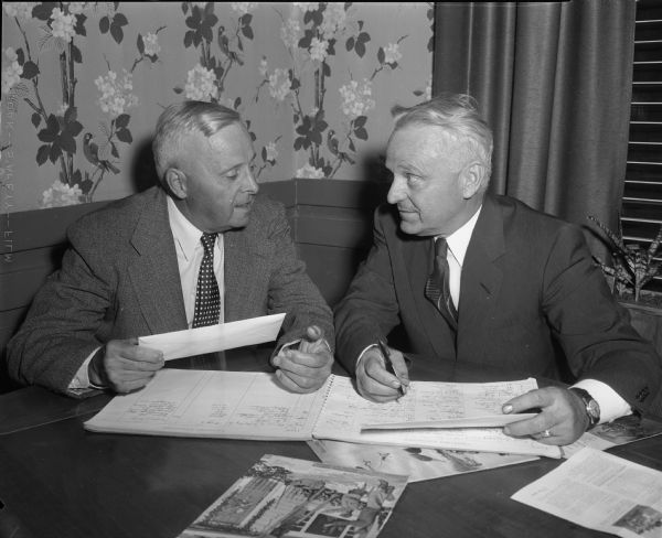 Harold Lampert and E.N. (Pim) Quinn discussing their proposal to bring the 1958 Elks National Association bowling tournament to Madison in 1958. They will present their plans in Louisville, Kentucky, on September 9, 1955.