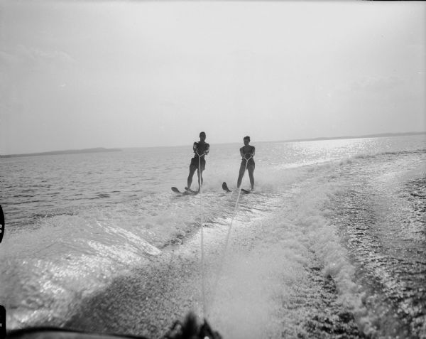 Lake Mendota water skiers, Joanna (Josie) Mayer, daughter of Mr. and Mrs. Gottfried Mayer, (523 Farwell Drive), and Jimmy Schneiders, son of Dr. and Mrs. E.F. Schneiders, (19 Fuller Drive), skiing on Lake Mendota.