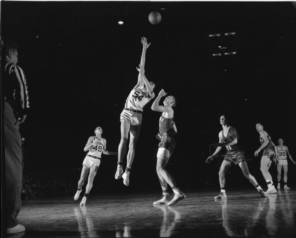 Wisconsin player number 54 attempts to make a basket at University of Wisconsin vs. University of Indiana basketball game.
