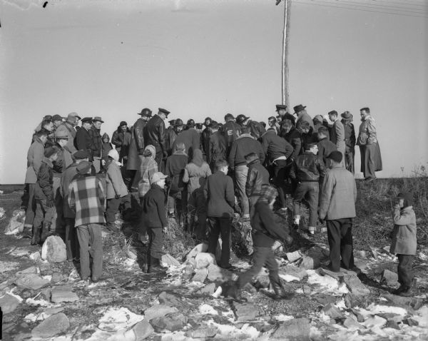 Crowd gathered around the shore of Monona Bay where Joel Hansen drowned, and his half brother Tommy Blankenheim was rescued.