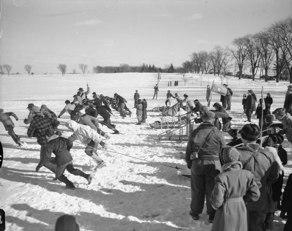 Group of boy scouts lined up for Klondike Derby sled race, where the boys pulled the sleds, on Monona Golf Course. Nearly 300 scouts from the Dane County area participated in "Operation Klondike" which tested the boys in first aid, ice rescue, fire building and compass knowledge.