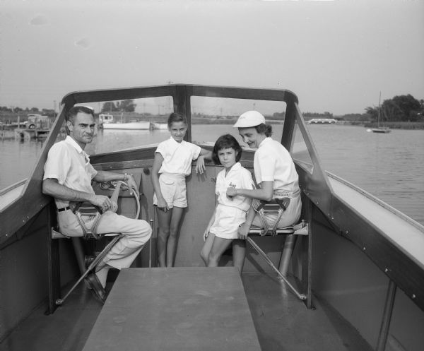 George and Jean Kaeser family in their boat on Lake Mendota with their daughters Virginia Kaeser (left), and Suzy Kaeser (right).