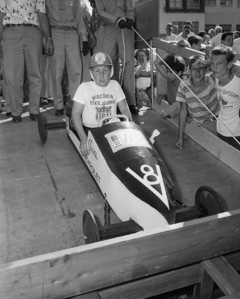 The Soap Box Derby held on East Washington Avenue leading from the Wisconsin State Capitol. Shown is racer Kenny Minett from Richland Center posing in his race car.