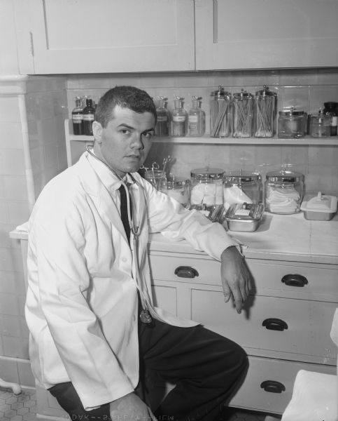 Medical student Bob Wheaton in the dispensary at the University of Wisconsin Medical School prior to receiving his M.D. degree.