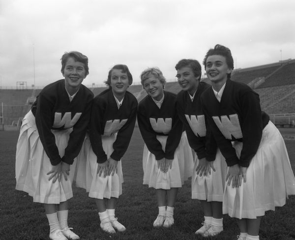 University of Wisconsin-Madison cheerleaders, Sandra Wahl, Sally Holmes, Diane Hansen, Donna Roehm, and Joni Froelich posed in Camp Randall Stadium.