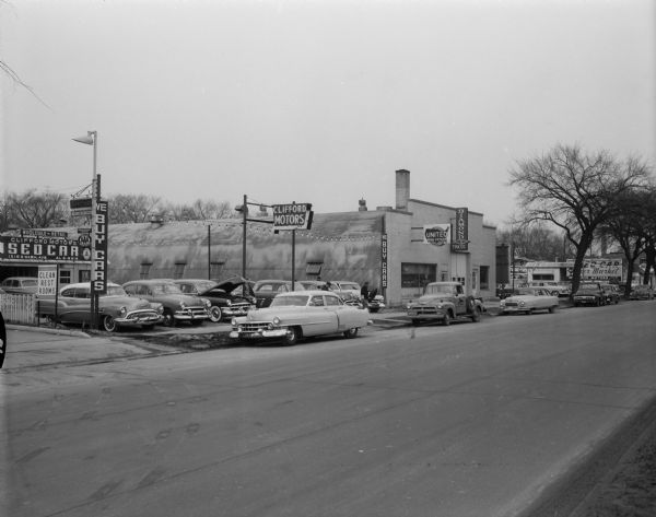 Clifford Motors Used Car Lot, 1210 East Washington Avenue.  Also included in the view is the United Real Estate office building, 1212 East Washington Avenue and Bilsie Diamond T Trucks Sales & Service, 1214 East Washington Avenue.
