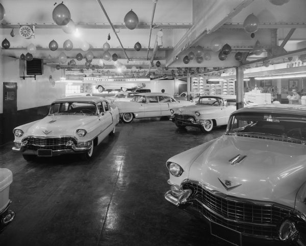 Four new Cadillac automobiles in Pyramid Motor Company showroom, 434 W. Gilman Street.
