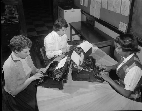 Central High School students, Nancee Meyers, Jean Loy, and Colenthia Hill working on an edition of the school newspaper, "Madison Mirror."