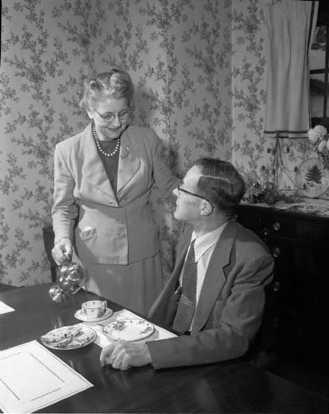 Wisconsin's new Secretary of State, Glenn M. Wise, pours coffee for her husband, John E. Wise, Sr., who is an electrical engineer with the state Industrial Commission.