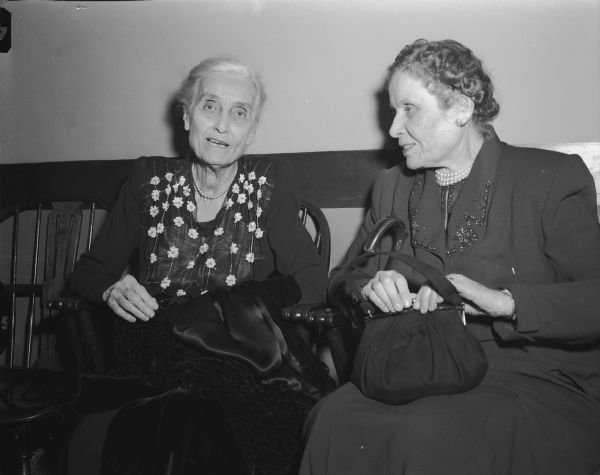 Mrs. Mary Richards and Mrs. Katherine Dodge, "gown" (university) members of the Madison Literary Club, chatting at the 75th anniversary banquet of the club.  The club also included "town" (city) members.