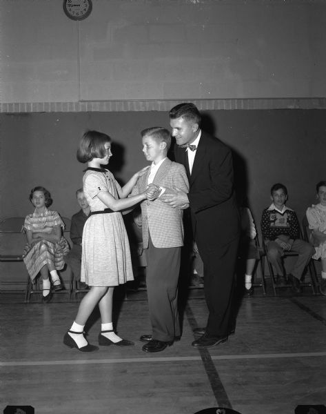 Jack G. Jefferds teaches basic dance steps to Marion Amlie and David Johnson at a Shorewood School dancing class.