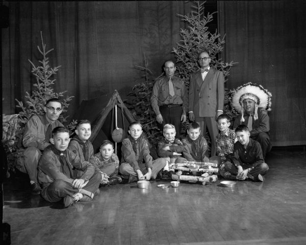 Lowell School Cub Scouts at a combined Christmas party and "Webelos" ceremony. Seated are boys James Kernan, Richard Schnurbusch, Ronald Wornson, Donald Norton, James Ellison, Jon Dresser, Loren Lewis, and Richard Lee (left to right). Behind are Scoutmaster Al Schnurbusch, Edwin Foerster, Serge Hummor, and Harold Habeck.