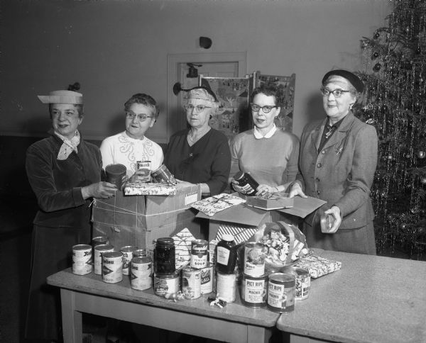 Order of Amaranth members packing food boxes for needy families. Shown, left to right: Bella Holly, Anna Hynum, Ruth Lieberman, and Myrtle Jessen.