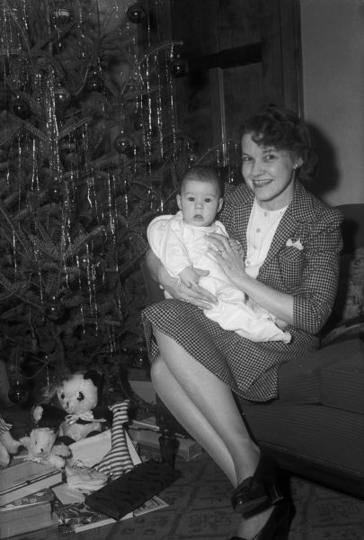 Patricia Fitzpatrick and her mother Frances Risdon Fitzpatrick, seated by a Christmas tree with opened presents, including several stuffed animals. Patricia was born Aug. 26, 1943. Her father was managing editor of the <I>Wisconsin State Journal</I>.