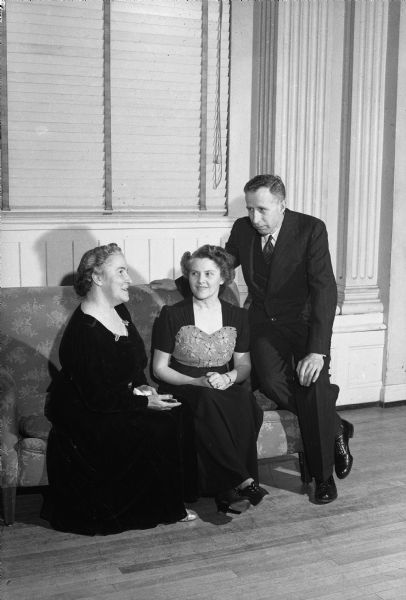 Margaret Garnett, who sang a group of selections, talking to Professor Harland W. Mossman and his wife, Ruth, at the University of Wisconsin University League dance reception at the Memorial Union. Mr. Mossman is an associate professor of anatomy at the medical school.