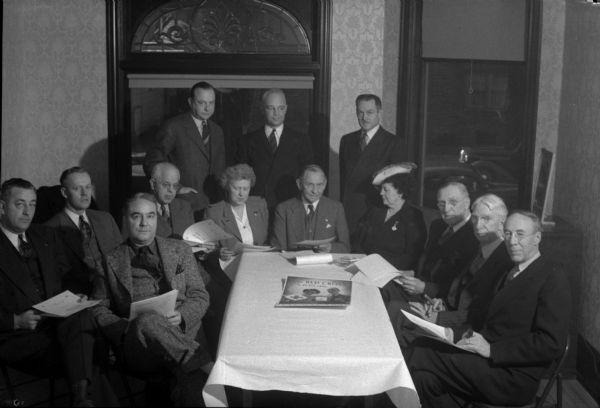 Workers for the Dane County chapter of the American Red Cross, (back row, left to right): W.H. Frederick, H.H. Kletzien, Arthur Towell; and (front row, left to right): Robert H. Gerry, Lawrence Larson, Leo Schlicht, Wallace W. Weaver, Lohra Davies, Louis Hirsig, June Wheeler, James R. Law, Louis Hanks, and Dr. Harold Bradley.