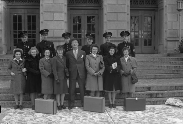 Six new female Marine Corp Women's Reserve prior to their departure for Camp Lejeune, New River, North Carolina; six Marines stationed at Truax Field; and "Roundy" Coughlin and his ward, Corporal Elizabeth Sullivan. Front row, left to right: Una Ticha, Sally Goodman, Norma Salyers, Elizabeth Sullivan, "Roundy" Coughlin, Norma Jennings, Winifred Joyce, Illa Johnson. Top row: Staff Sgt. R.W. Kramer, Staff H.E. Clements, Tech. Sgt. H.R. Henn, Staff Sgt. E.F. Killian, Staff Sgt. R.T. Redling, and Staff Sgt. L.R. Ernce.