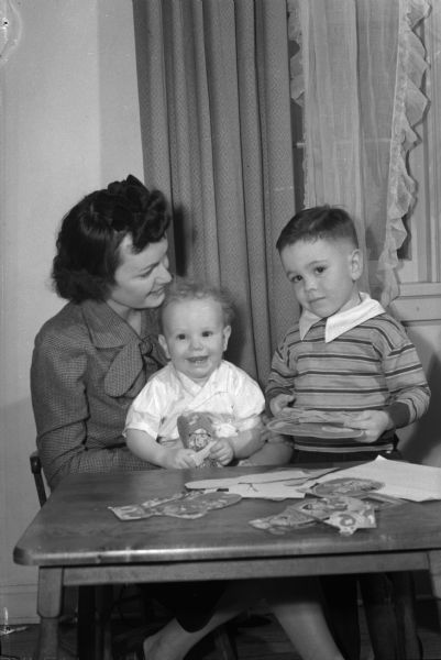 Audrey Walsh and her sons, David and John, looking at Valentines. John J. Walsh, the boys' father, is the boxing coach at the University of Wisconsin.