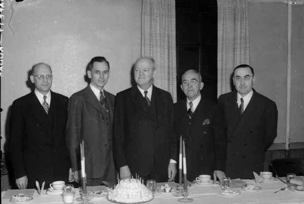 Speakers and officials at the 25th "birthday" of the Madison YMCA.  Left to right are Oscar Christianson; Robert M. Eickmeyer, YMCA General Secretary; Emerson Ela; Frederick O. Leister; and Walter Ebling.