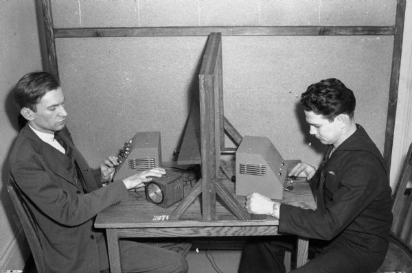 Two men involved in an experiment in a University of Wisconsin psychology laboratory.