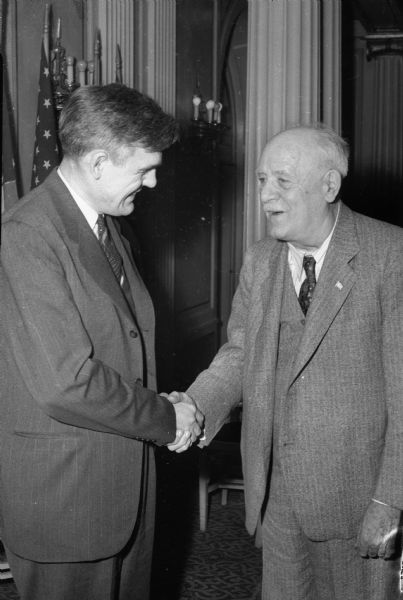 United States Senator Joseph H. Ball (R-Minn.), shaking hands with acting Governor Goodland at a luncheon for Republican Presidential candidate Harold E. Stassen.
